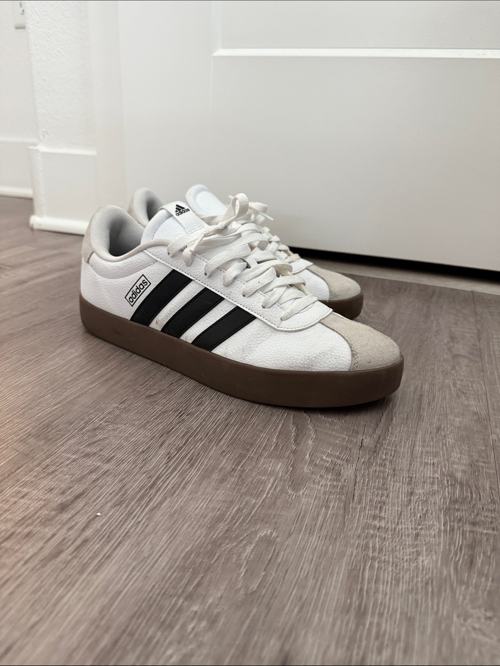 adidas Menโs White Sneakers with Black Stripes and Brown Sole
